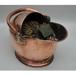 A 19TH CENTURY COPPER HELMET FORM COAL SCUTTLE, with swing handle, height; 24cm (to the top of the