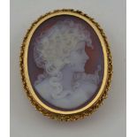 AN OVAL CARVED SHELL CAMEO, depicting a portrait of a young woman in profile, mounted in a 9ct