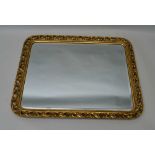 A DECORATIVE GILT FRAMED WALL MIRROR, pierced acanthus leaf design, fitted bevel plate glass, 44cm x