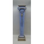 A REGENCY DESIGN PAINTED POTTERY DISPLAY COLUMN, of ionic form, with rosette and graduated bell