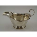 REID & SONS A SILVER SAUCE BOAT, having acanthus leaf scroll handle, Sheffield 1946, weight; 119g