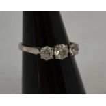 A THREE STONE DIAMOND RING, the brilliant cut stones set to an 18ct white gold band, ring size P