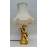 A GILT CHERUB TABLE LAMP with shade