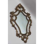 AN ORNATE FRAMED WALL MIRROR, acanthus scroll gilded frame, overall size; 74cm x 46cm