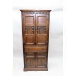 AN "OLD CHARM" OAK CABINET IN THE 17TH CENTURY STYLE, with carved panelled decoration, fitted two