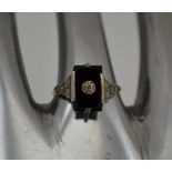 A LADY'S GOLD & SILVER DRESS RING, inset rectangular black stone, possibly jet, ring size; "P1/2"