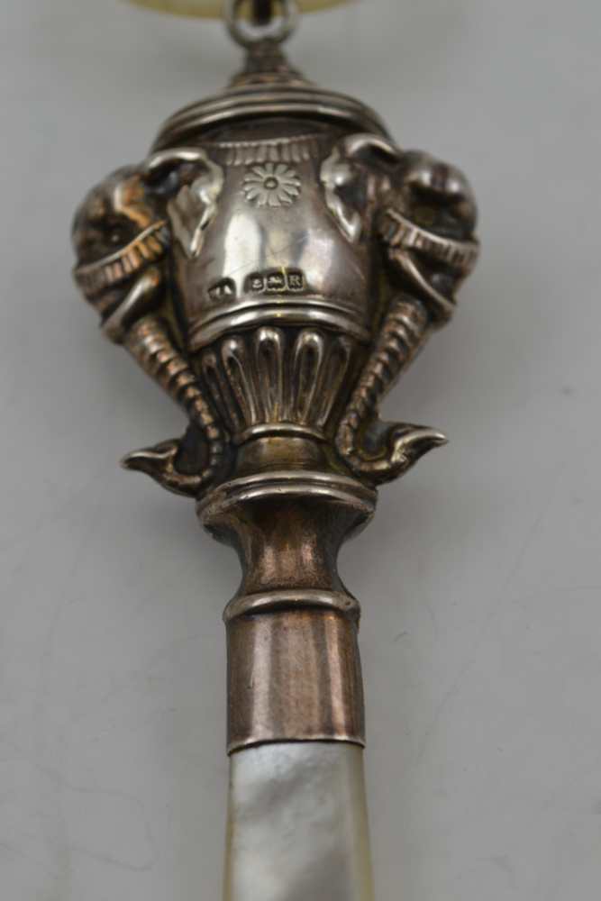 WILLIAM ADAMS LTD A SILVER CHILD'S RATTLE, having embossed elephant head decoration, with mother - Image 3 of 5