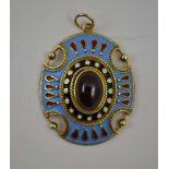 A 9CT GOLD OVAL PENDANT, the enamelled decoration in the Egyptian Revival taste, inset central