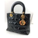 A CHRISTIAN DIOR "LADY DIOR" QUILTED BLACK PATENT HANDBAG, cannage top stitching, gilt brass