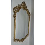 A DECORATIVE BRASS FRAMED WALL MIRROR, overall size; 122cm x 73cm
