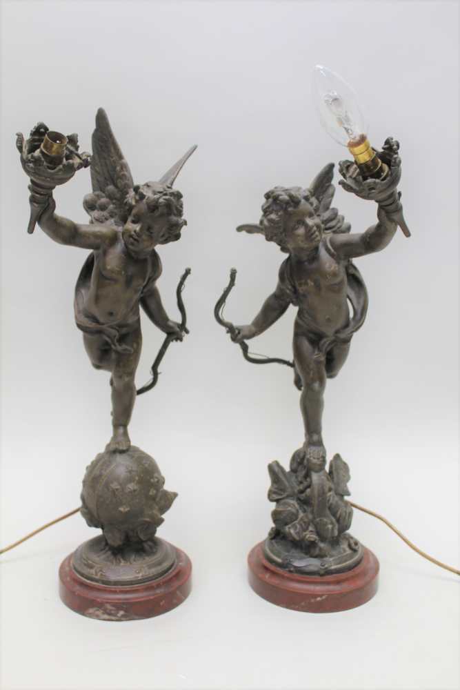 A PAIR OF EARLY 20TH CENTURY FRENCH BRONZE EFFECT SPELTER TABLE LAMPS, of cherub design, both with