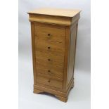 A CONTEMPORARY OAK "WARING & GILLOW" CHEST OF FIVE DRAWERS with metal knob handles, on bracket feet,