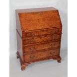 A GEORGIAN DESIGN BURR VENEER WRITING BUREAU, the fallfront opening to reveal a fitted interior,