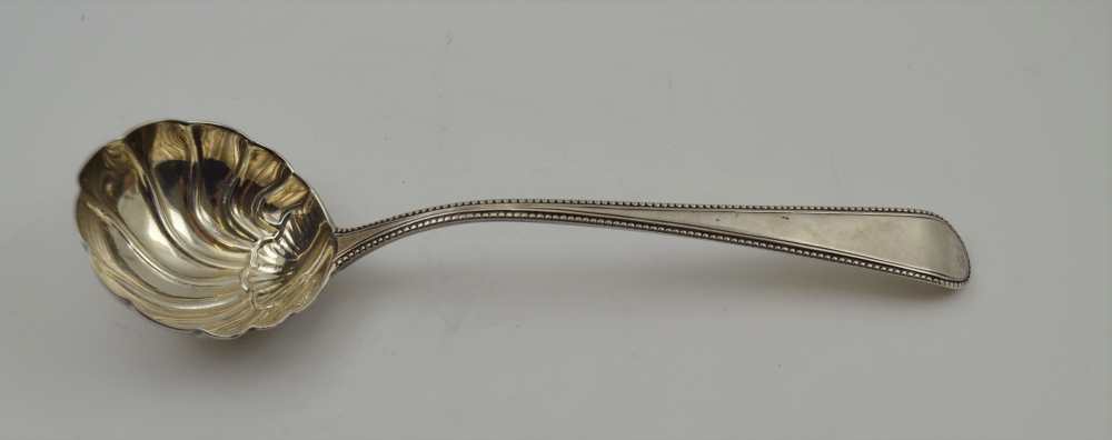 GEORGE SMITH AN 18TH CENTURY SILVER SHELL BOWLED LADLE, with bead edge handle, London 1783,