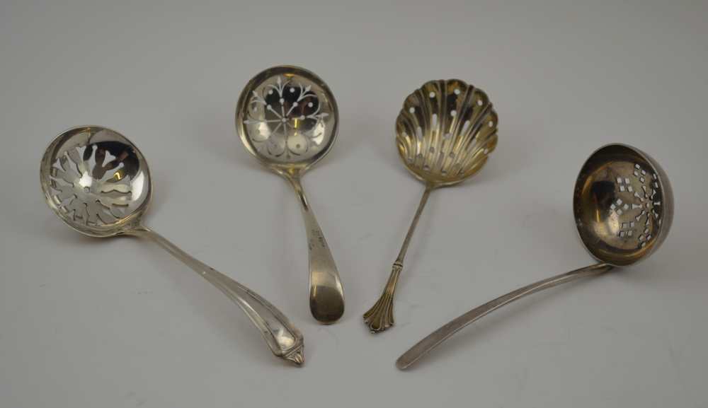 FOUR VARIOUS SILVER SIFTING LADLES, various designs and assay marks, to include the years; 1909,