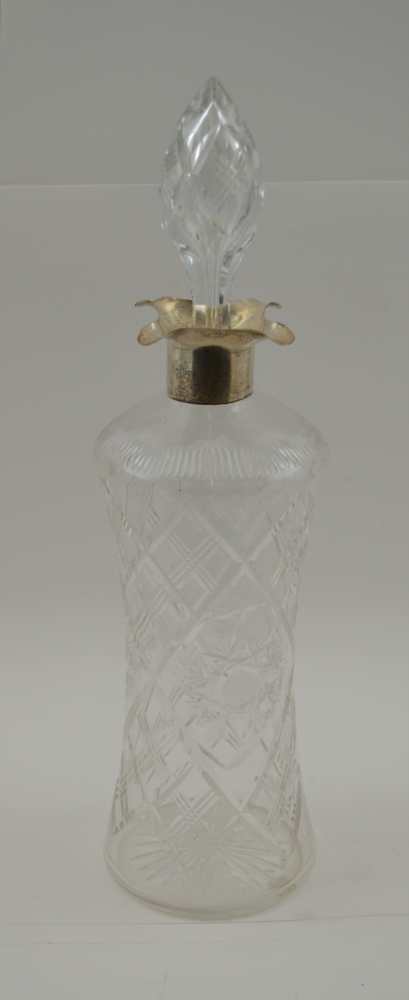 ELKINGTON & CO. A CUT GLASS DECANTER, with silver collar and four pouring lips, London 1906,