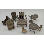 A COLLECTION OF DUTCH WHITE METAL MINIATURES, to include; furniture, Sedan chair, peacock, the