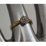 A LADY'S DRESS RING, cluster set with diamonds and to the shoulders, ring size; "K1/2"