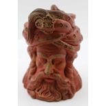 A VICTORIAN POTTERY TOBACCO JAR in the form of a "Turks" head, having removable cover, red coloured