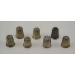 SEVEN HALLMARKED SILVER THIMBLES, of various designs and makers
