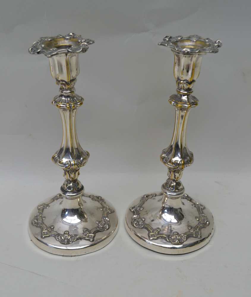 A PAIR OF SILVER PLATED CANDLESTICKS, 24.5cm high