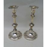 A PAIR OF SILVER PLATED CANDLESTICKS, 24.5cm high