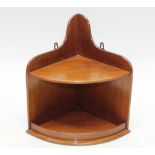 A SMALL MAHOGANY WALL MOUNTING CORNER SHELF UNIT, of bow front form, 34cm wide