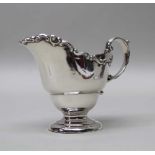 A SILVER CREAM JUG, London 1911, 105g