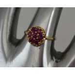 A LADY'S 14K GOLD DRESS RING, inset ruby cluster, ring size; "N"