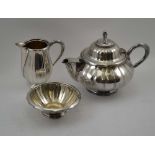 A WMF ELECTRO-PLATED THREE PIECE TEA-SET of melon form, comprising tea pot, milk jug and sugar