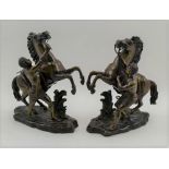 AFTER GUILLAUME COUSTOU A PAIR OF BRONZE MARLEY HORSES, rearing horses with grooms, on rockwork