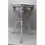 A VICTORIAN CAST IRON BASED GARDEN TABLE, the shaped wooden top over base with mask decoration,