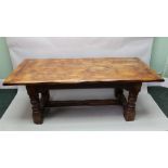 A 17TH CENTURY DESIGN OAK REFECTORY TABLE, having plank top on ring turned supports, with lunette