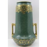 A ROYAL WORCESTER VASE of cylindrical form, fitted a pair of gilded handles, mottled green celadon