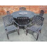 A CAST ALUMINIUM GARDEN SET, comprising a 5ft diameter table and six armchairs, of lattice design