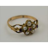 A 19TH CENTURY DRESS RING, pearls and amethysts mounted in yellow metal, of stylised flower head