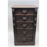 A LATE VICTORIAN OAK WELLINGTON CHEST, fitted five drawers with carved mask handles, 57cm wide x