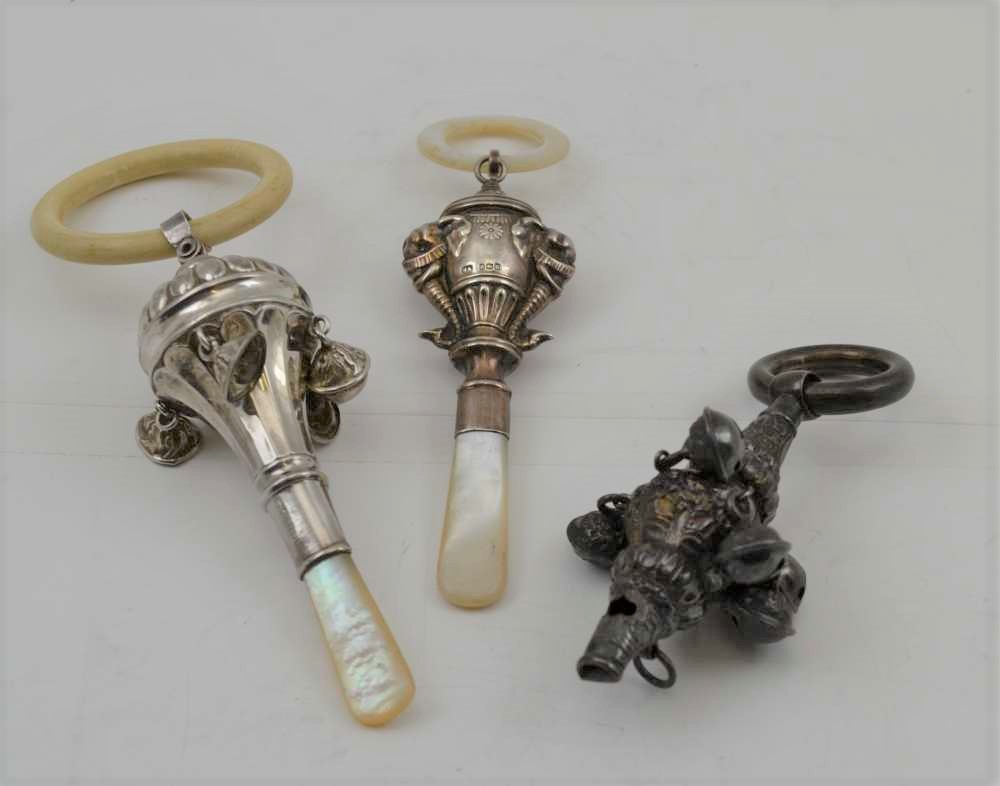 WILLIAM ADAMS LTD A SILVER CHILD'S RATTLE, having embossed elephant head decoration, with mother