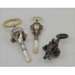 WILLIAM ADAMS LTD A SILVER CHILD'S RATTLE, having embossed elephant head decoration, with mother