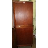 A TEAK TWO DOOR FREESTANDING CORNER CUPBOARD