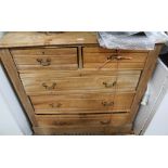 A SCRUBBED SOFTWOOD CHEST OF FIVE DRAWERS on plain plinth base