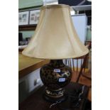 A DECORATIVE POTTERY BASED TABLE LAMP with old gold silk effect shade