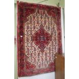 AN IRANIAN WOVEN WOOLEN FLOOR CARPET having central lozenge & stylised flowers, within a triple