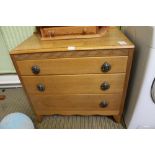 A LOW LIGHT OAK THREE DRAWER CHEST