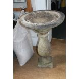 A TWO PIECE CAST CONCRETE BIRDBATH on baluster column