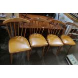A SET OF FOUR BEECH RETRO SPINDLE BACK KITCHEN CHAIRS with rexcine seat pads