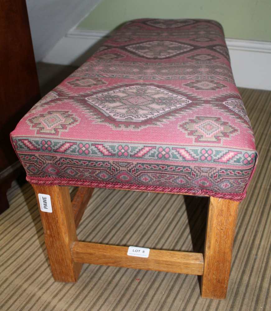 A DOUBLE WIDTH PADDED TOPPED FOOTSTOOL with kelim effect upholstery