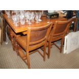 A 20TH CENTURY LIGHT OAK DINING SUITE comprising draw leaf table & four chairs