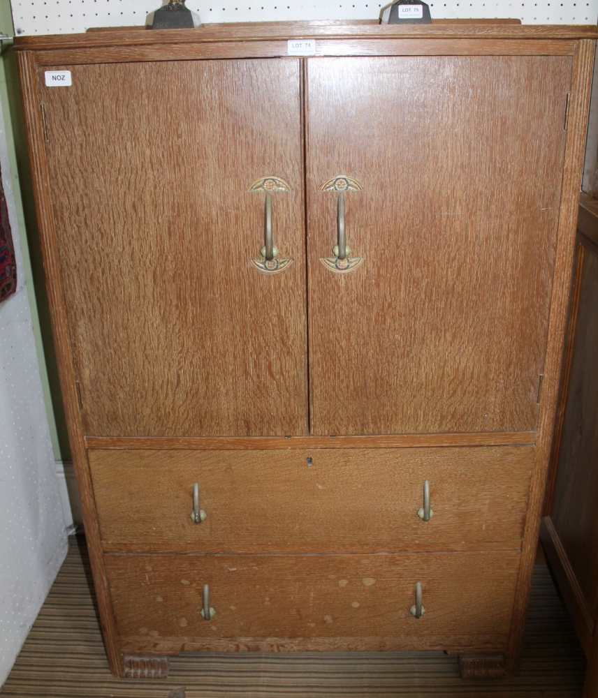 A SCRUBBED OAK TALLBOY STYLE UNIT with two cupboard doors over two full width drawers