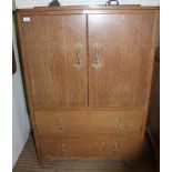 A SCRUBBED OAK TALLBOY STYLE UNIT with two cupboard doors over two full width drawers